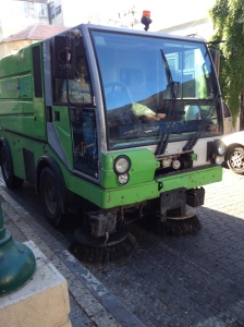 A street sweeper in Yafo.  Notice how filthy the sidewalk (and uncleaned street) is.